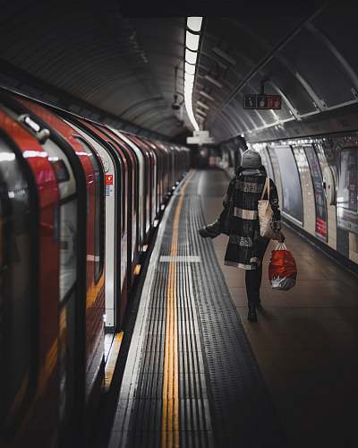 london woman stand beside train train station